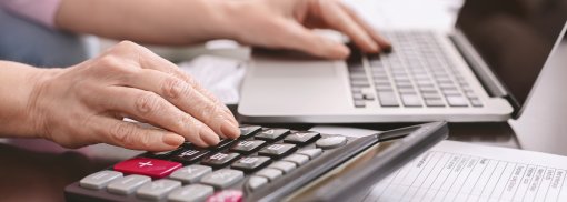 © Senior woman with calculator counting dollar money at home - Prostock-studio Diese Dinge ändern sich für Autofahrer in 2021